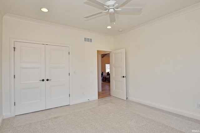 unfurnished bedroom featuring ceiling fan, ornamental molding, and a closet