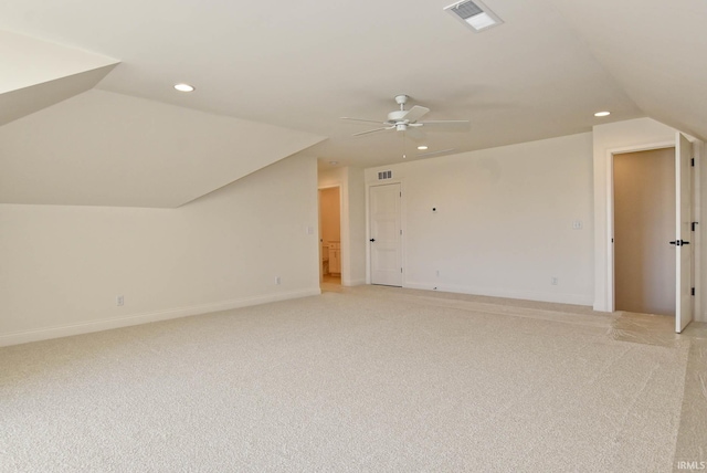 additional living space featuring light carpet, vaulted ceiling, and ceiling fan