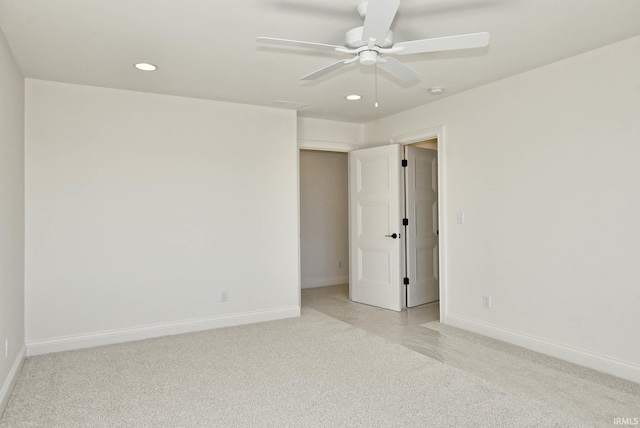 empty room with ceiling fan and light carpet