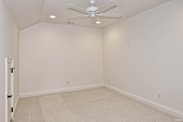 carpeted empty room featuring ceiling fan and lofted ceiling