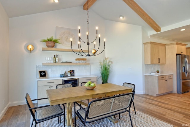 dining room with wine cooler, lofted ceiling with beams, light hardwood / wood-style floors, and bar