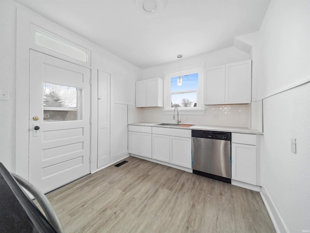 kitchen featuring sink, decorative light fixtures, white cabinets, and dishwasher