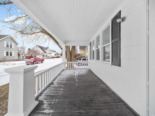 snow covered patio featuring a porch