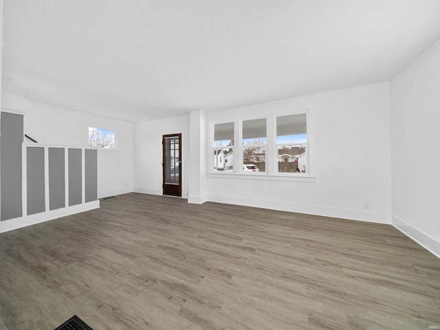 empty room with dark hardwood / wood-style flooring