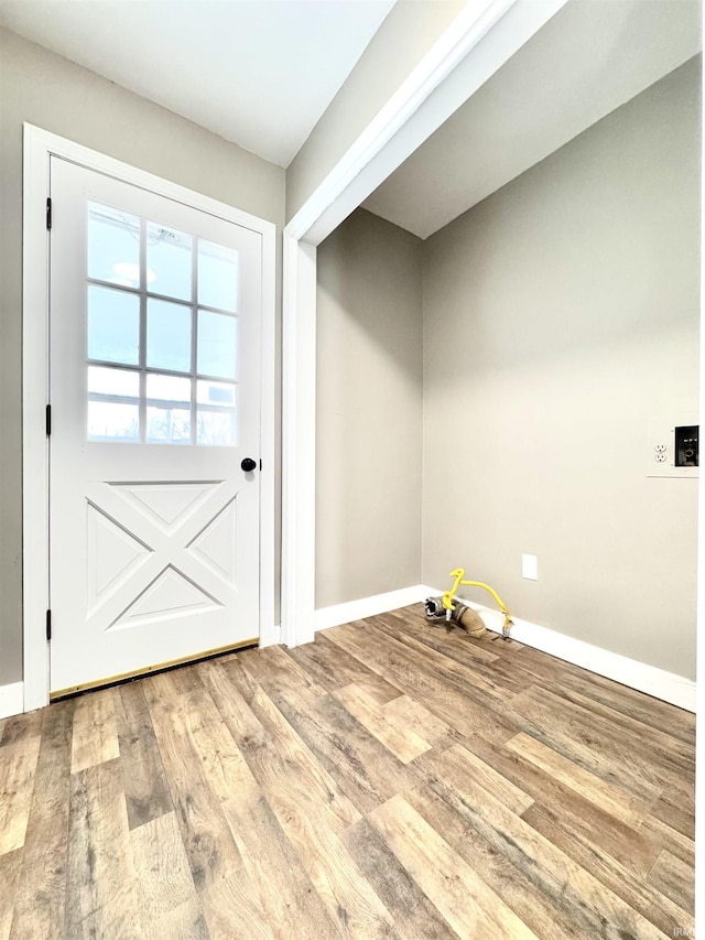 doorway to outside with wood finished floors and baseboards