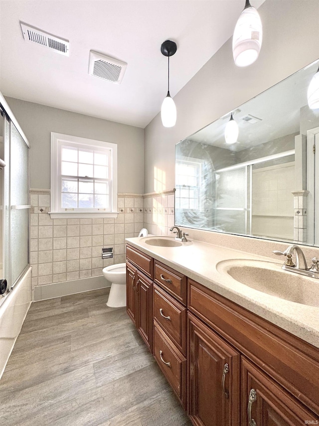 full bathroom with double vanity, a sink, and visible vents