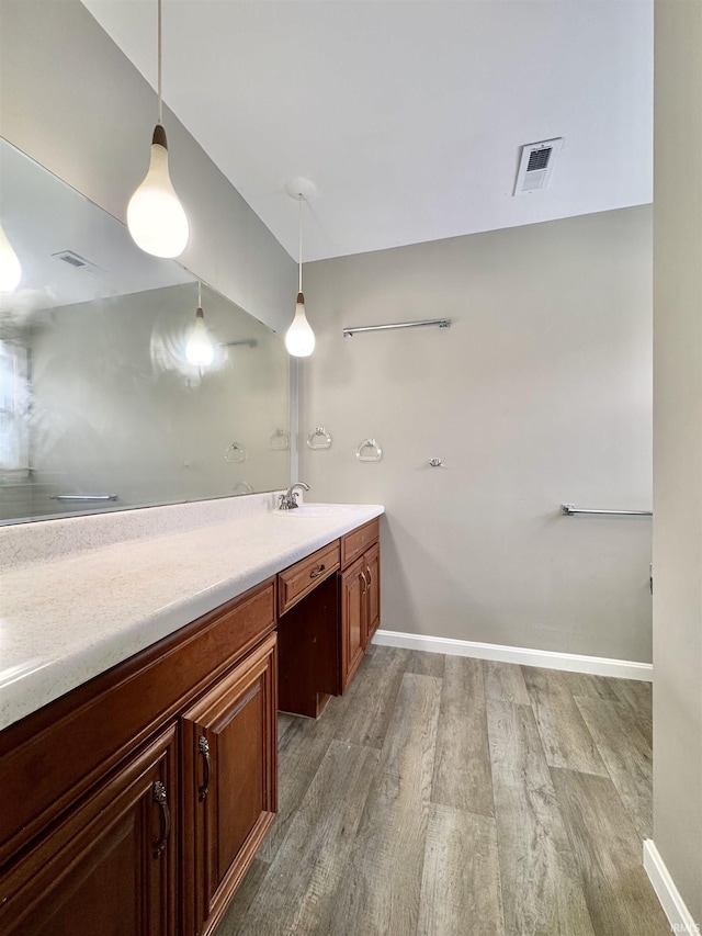 full bathroom featuring baseboards, visible vents, wood finished floors, and vanity