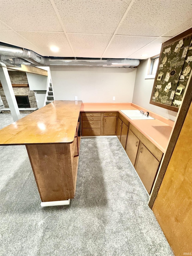 bar featuring a drop ceiling and a sink