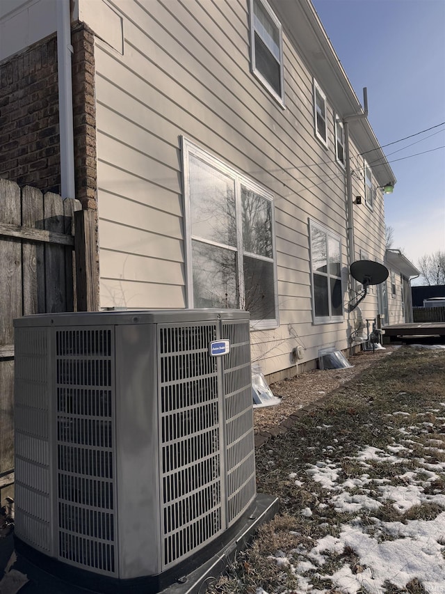 view of side of home with central AC