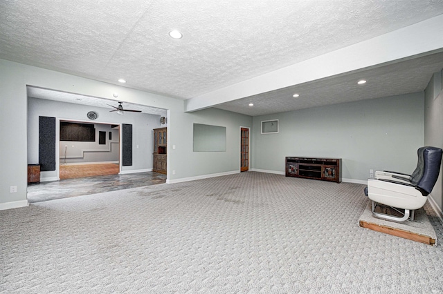 sitting room featuring ceiling fan, carpet flooring, and a textured ceiling