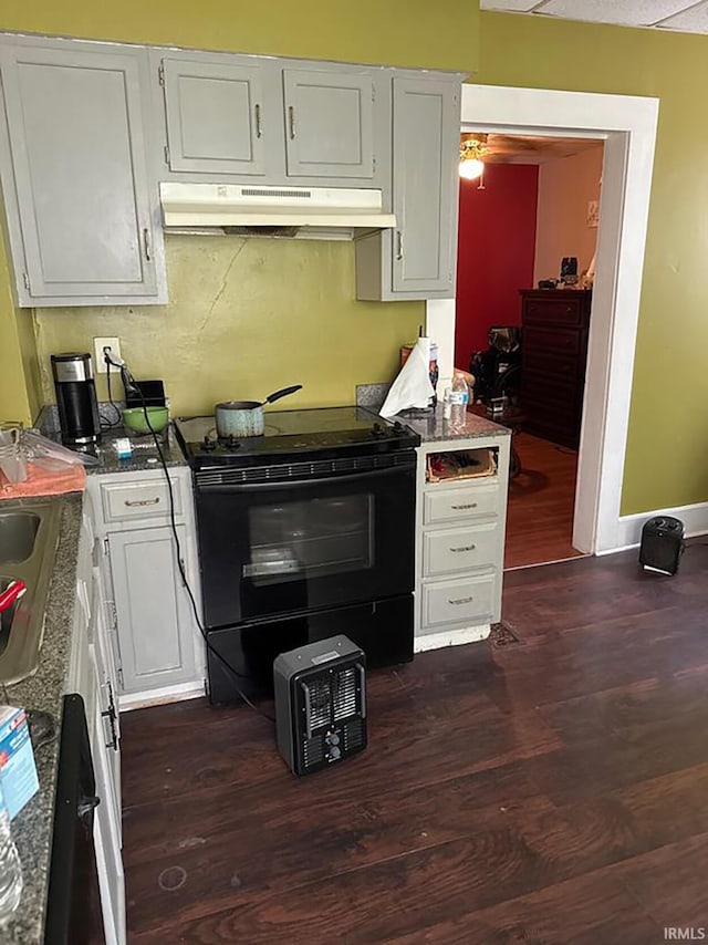 kitchen with white cabinetry, dark wood-type flooring, and black / electric stove