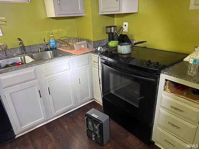 kitchen with white cabinetry, black electric range oven, sink, and dark hardwood / wood-style flooring