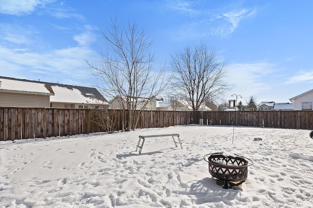 snowy yard featuring an outdoor fire pit