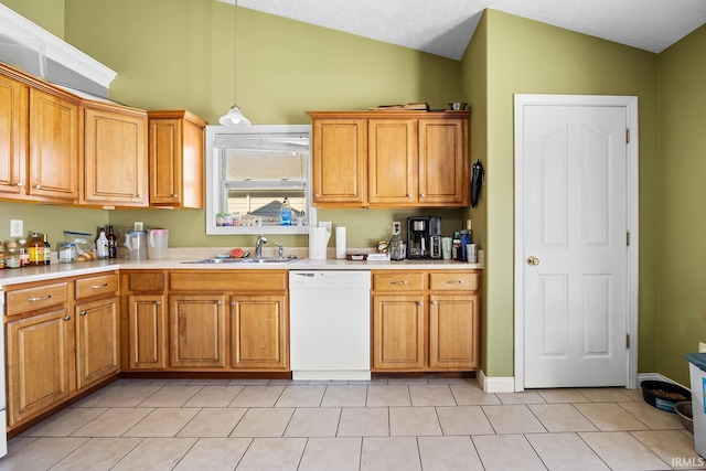 kitchen with sink, dishwasher, vaulted ceiling, and light tile patterned floors