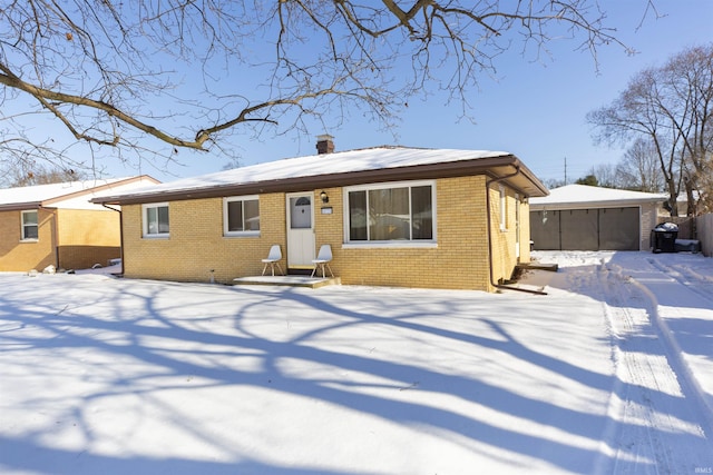 view of front of property with a garage and an outdoor structure