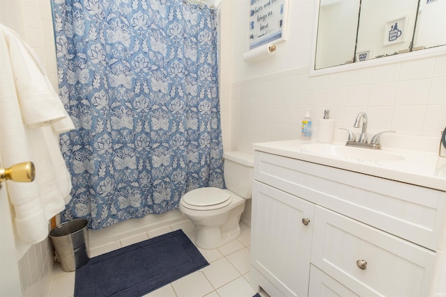 bathroom featuring tile walls, vanity, tile patterned floors, and toilet