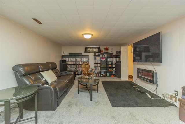 living room with a fireplace and carpet floors