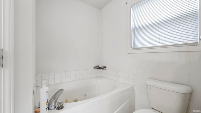 bathroom with a washtub and toilet