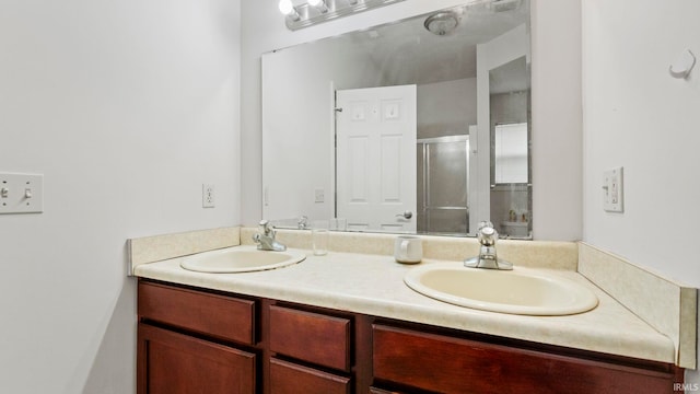 bathroom featuring vanity and an enclosed shower