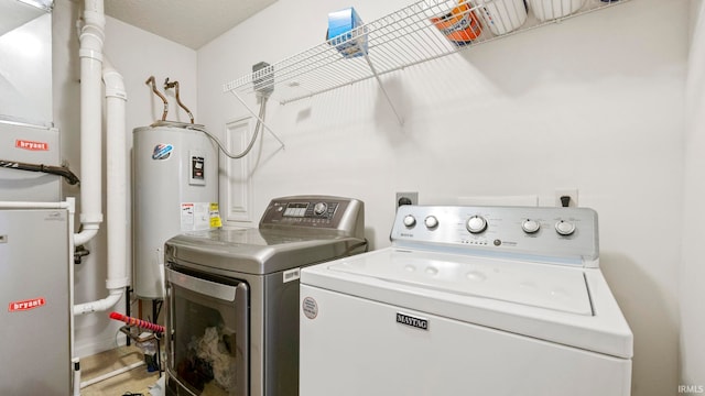 laundry area featuring separate washer and dryer and water heater