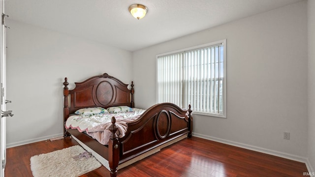 bedroom featuring dark hardwood / wood-style floors