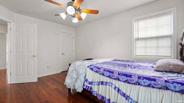 bedroom with dark wood-type flooring and ceiling fan