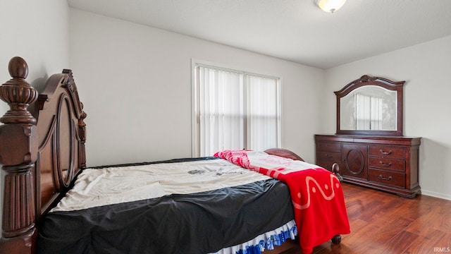 bedroom with dark hardwood / wood-style floors