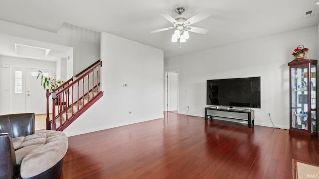 living room featuring ceiling fan and dark hardwood / wood-style floors