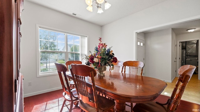 dining area featuring an inviting chandelier and light wood-type flooring