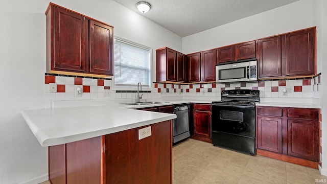 kitchen with sink, kitchen peninsula, decorative backsplash, and black appliances