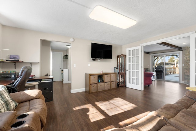 living room featuring dark wood-type flooring and a textured ceiling