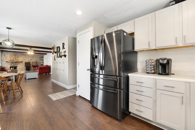 kitchen featuring dark wood-type flooring, stainless steel fridge with ice dispenser, and white cabinets