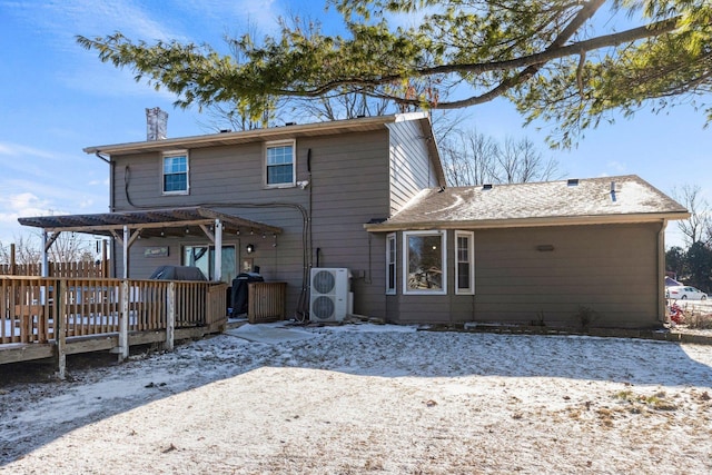 snow covered rear of property featuring a wooden deck