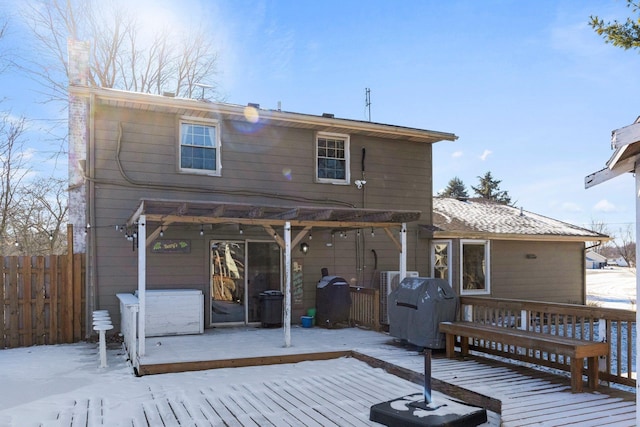 snow covered property featuring a deck