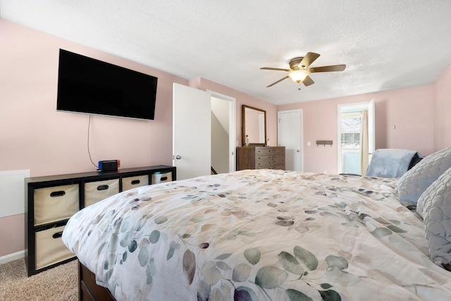 bedroom with carpet flooring, a textured ceiling, and ceiling fan