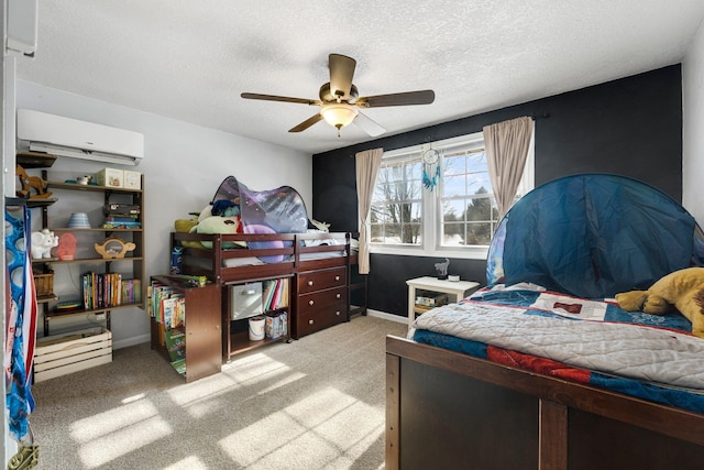 bedroom featuring ceiling fan, light colored carpet, a wall unit AC, and a textured ceiling