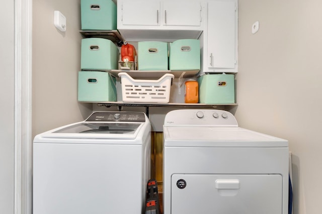 laundry area featuring cabinets and washer and dryer