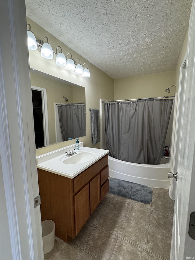 bathroom featuring vanity, a textured ceiling, and shower / bath combo