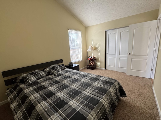 bedroom with vaulted ceiling, light carpet, a closet, and a textured ceiling