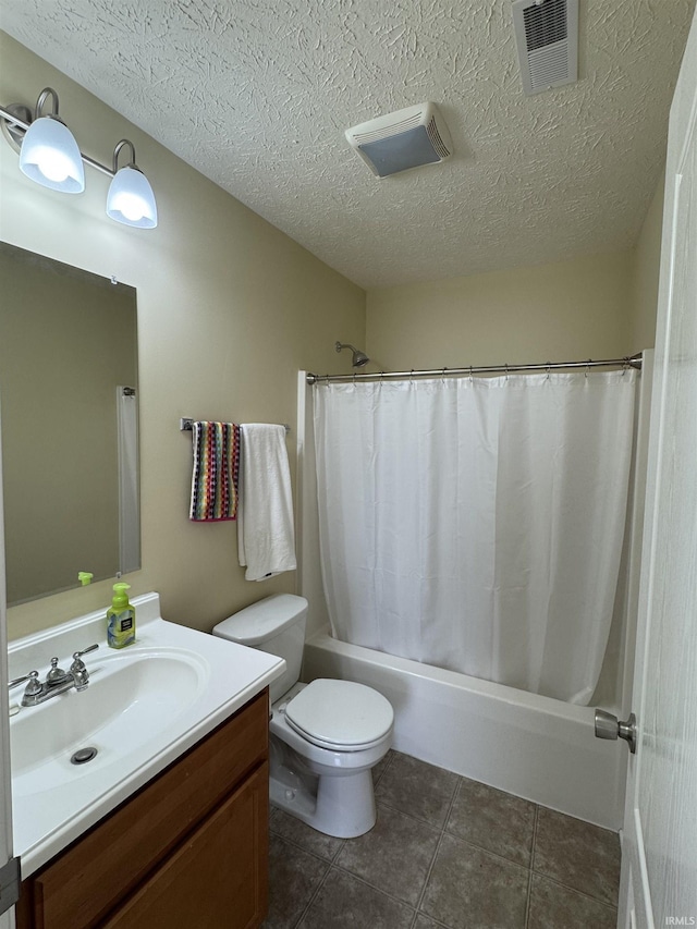 full bathroom featuring vanity, shower / bath combination with curtain, a textured ceiling, tile patterned floors, and toilet