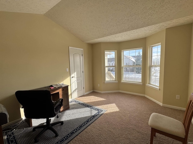 home office featuring vaulted ceiling, light carpet, and a textured ceiling