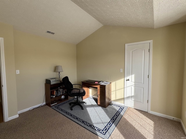 carpeted office with vaulted ceiling and a textured ceiling