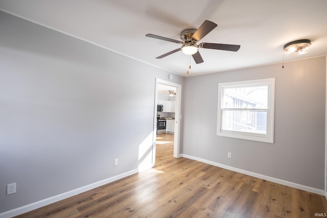 unfurnished room featuring hardwood / wood-style floors and ceiling fan