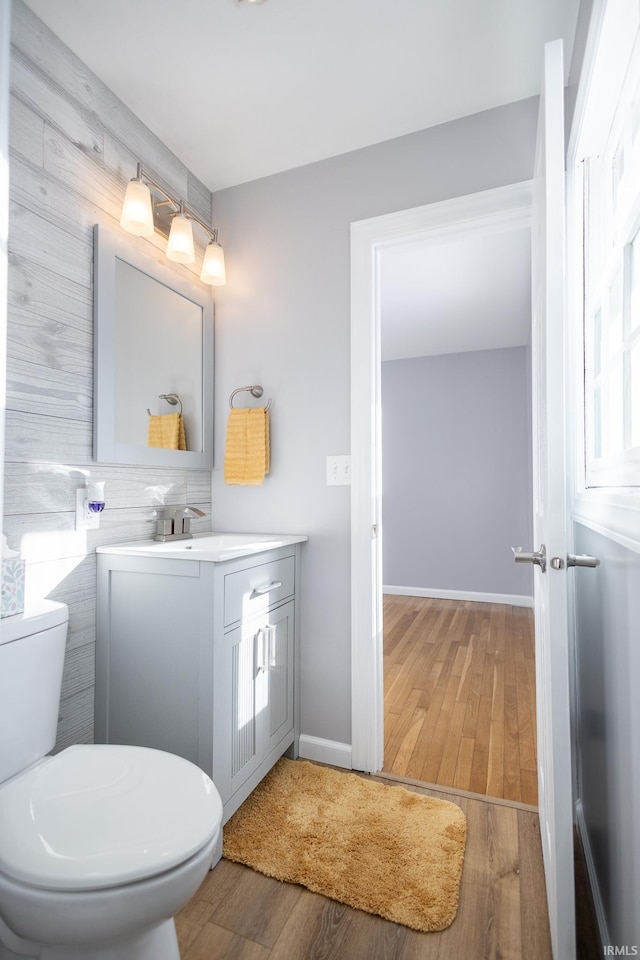 bathroom with vanity, hardwood / wood-style flooring, and toilet