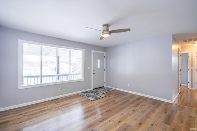 foyer entrance with wood-type flooring and ceiling fan