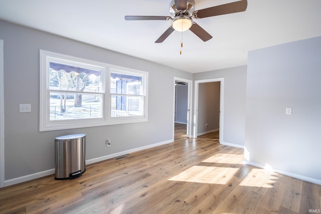 unfurnished room featuring ceiling fan and light wood-type flooring