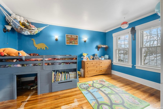 bedroom featuring wood-type flooring and ornamental molding