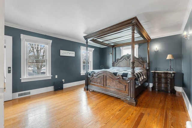 bedroom featuring ornamental molding and hardwood / wood-style floors