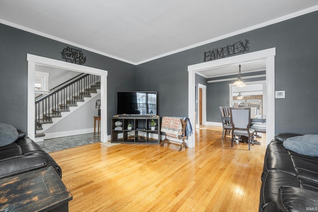 living room featuring crown molding and hardwood / wood-style flooring