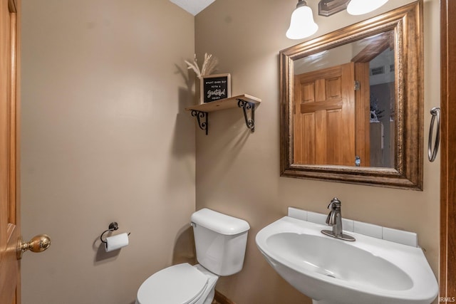 bathroom with sink and toilet